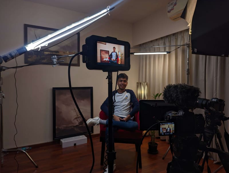 Kunal seated under studio lights while a crew films an interview for Superteens.